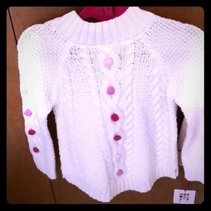 White sweater with pink Pom poms